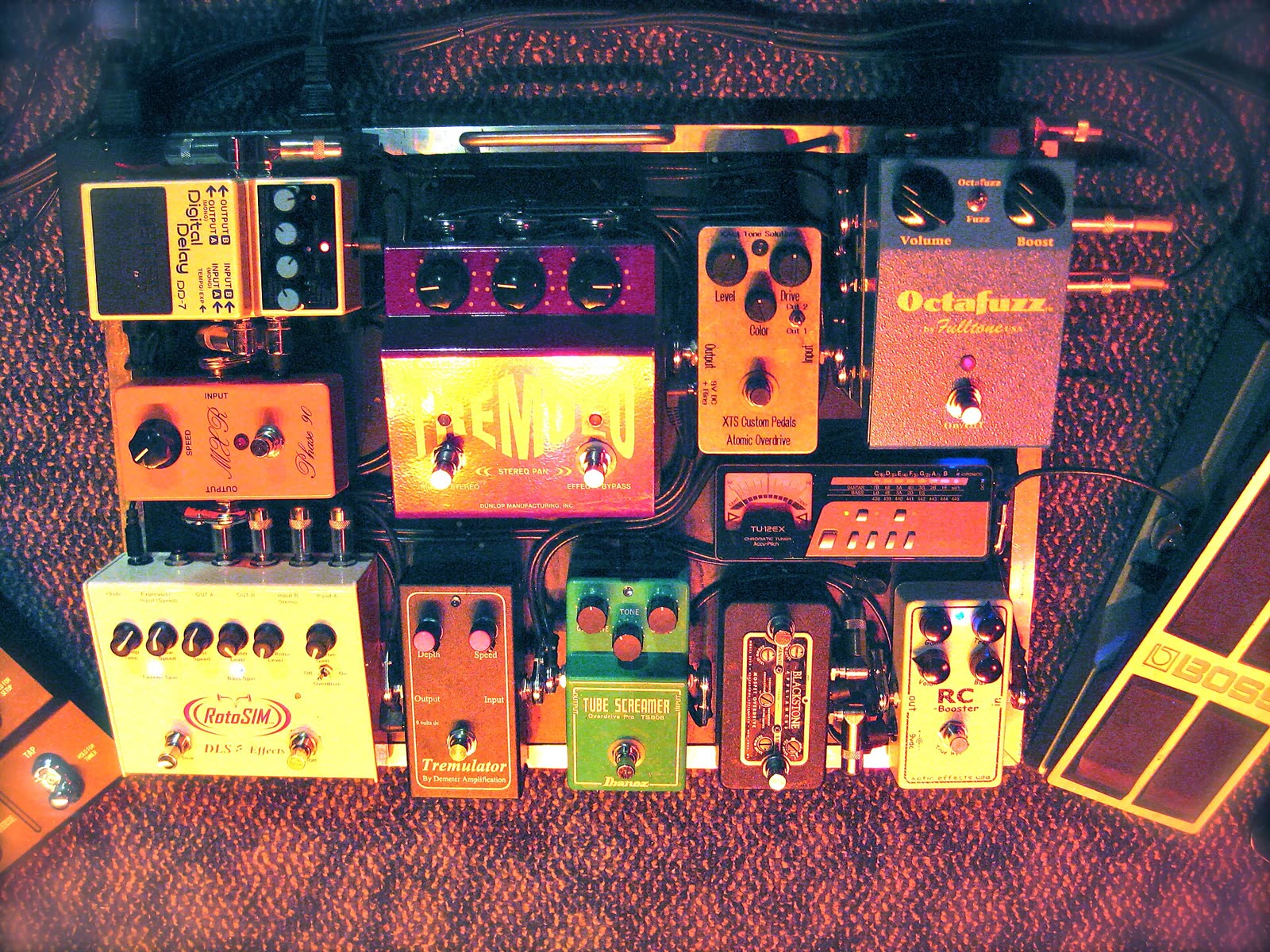 A guitarist’s pedalboard, a dozen pedals cabled together
